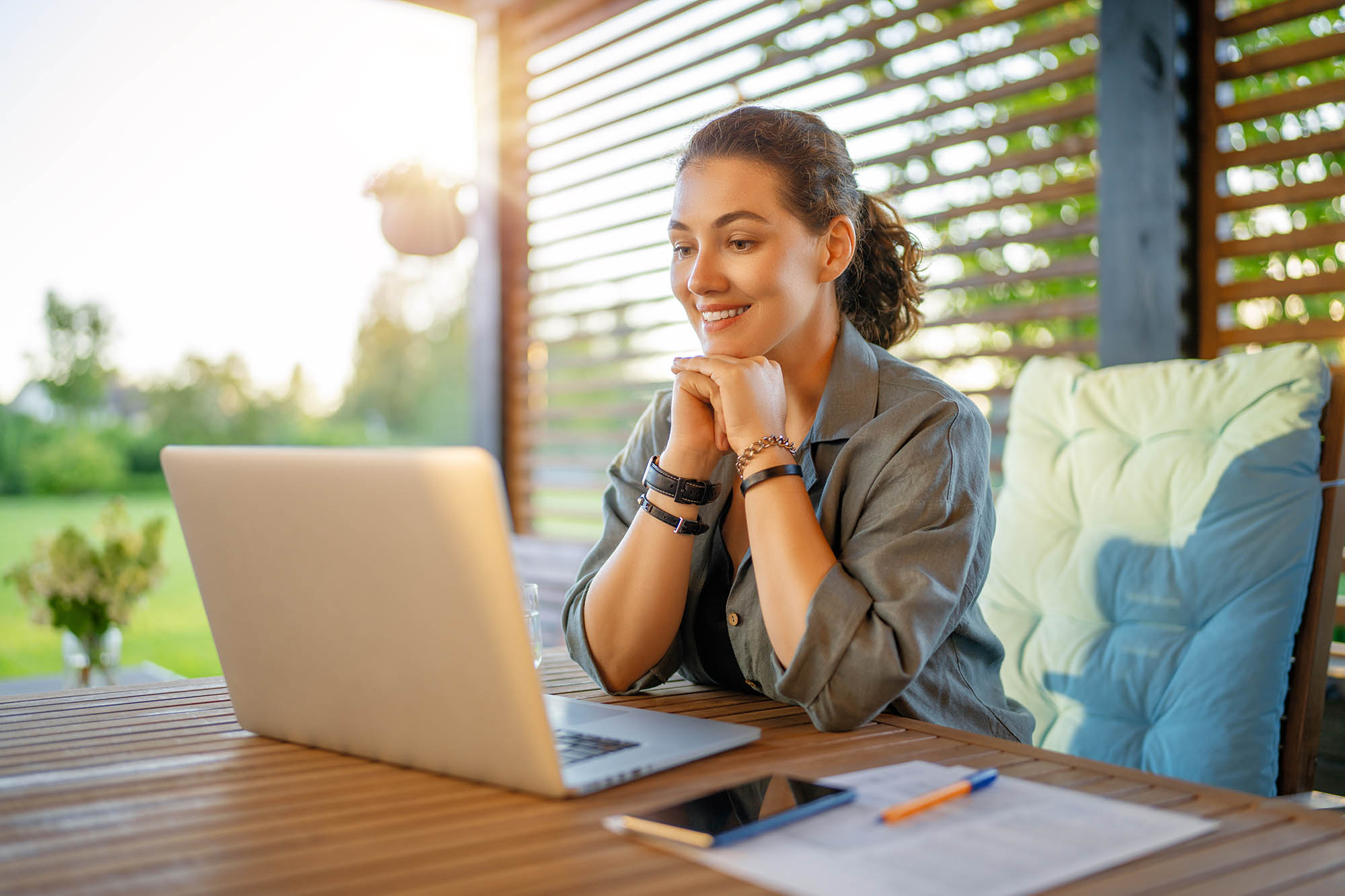 Accounting professional smiling during video call while working on financial close management tasks remotely