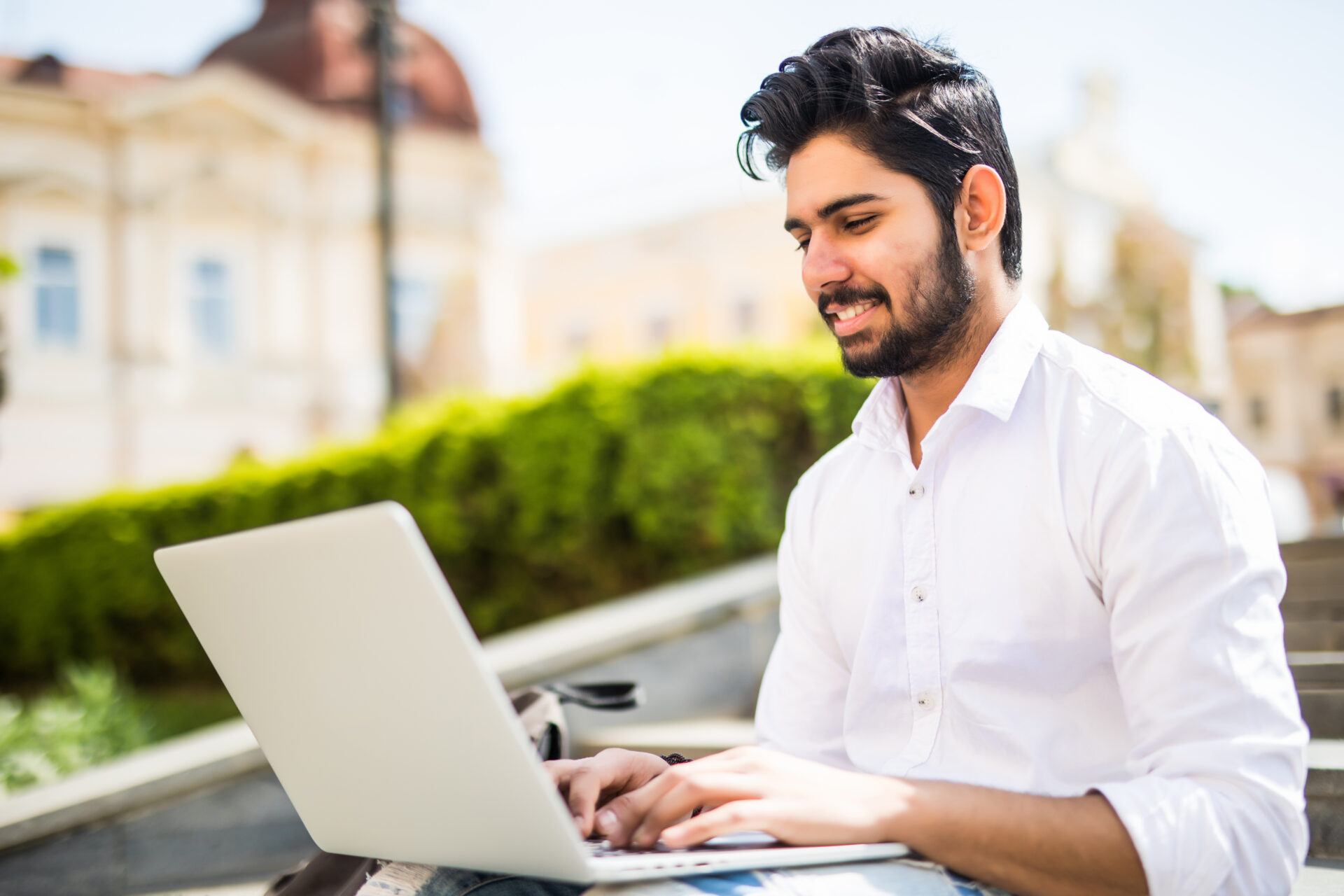 young man working on a laptop outside