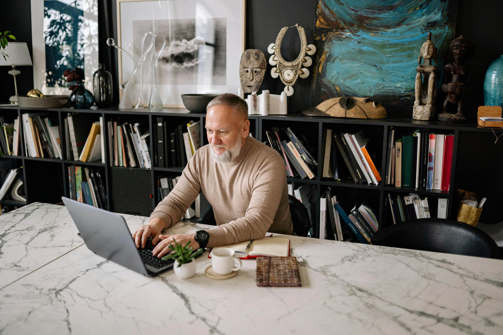 CFO working remotely on laptop using financial reporting software in home office