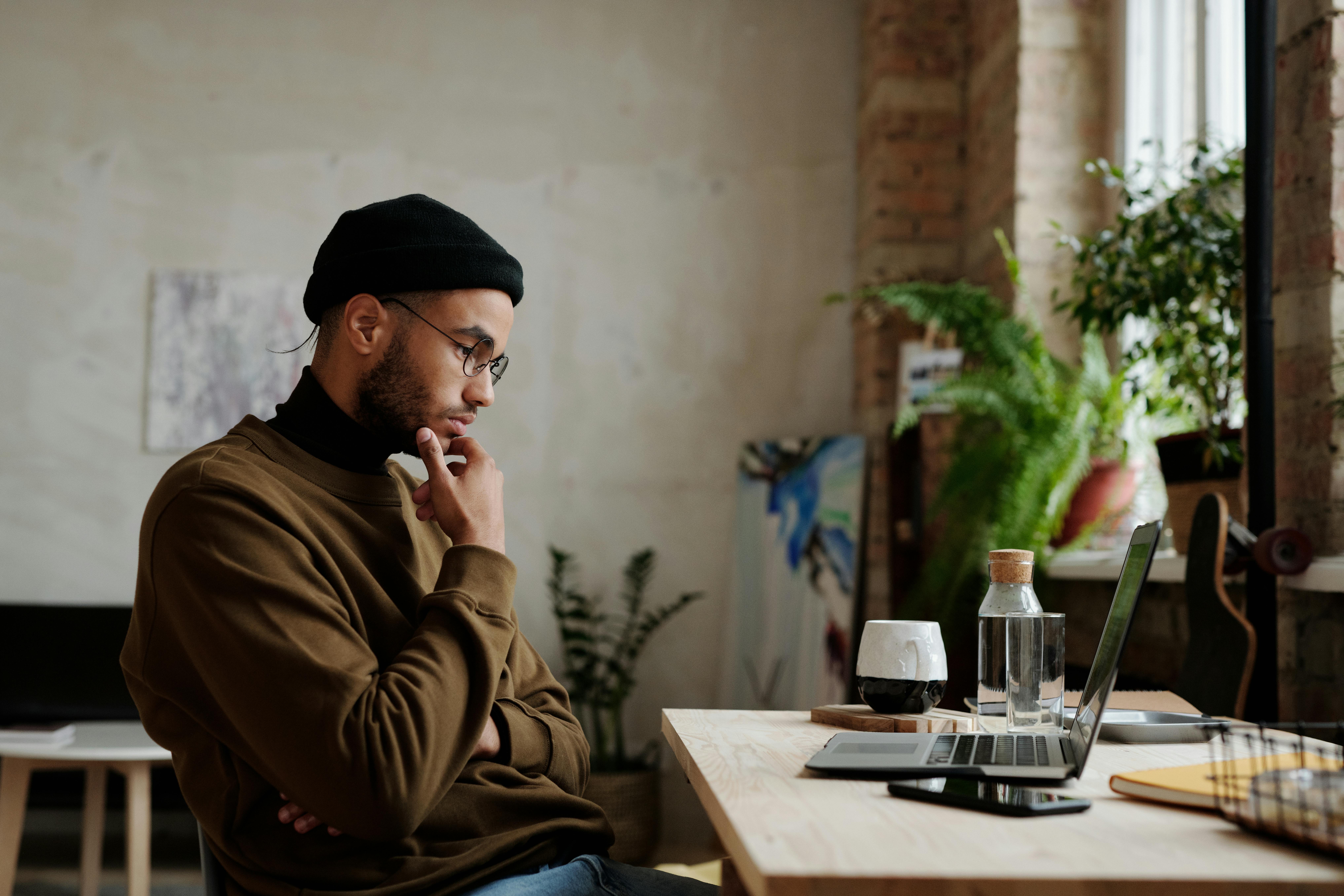 Young man reviewing financial reconciliations on a computer
