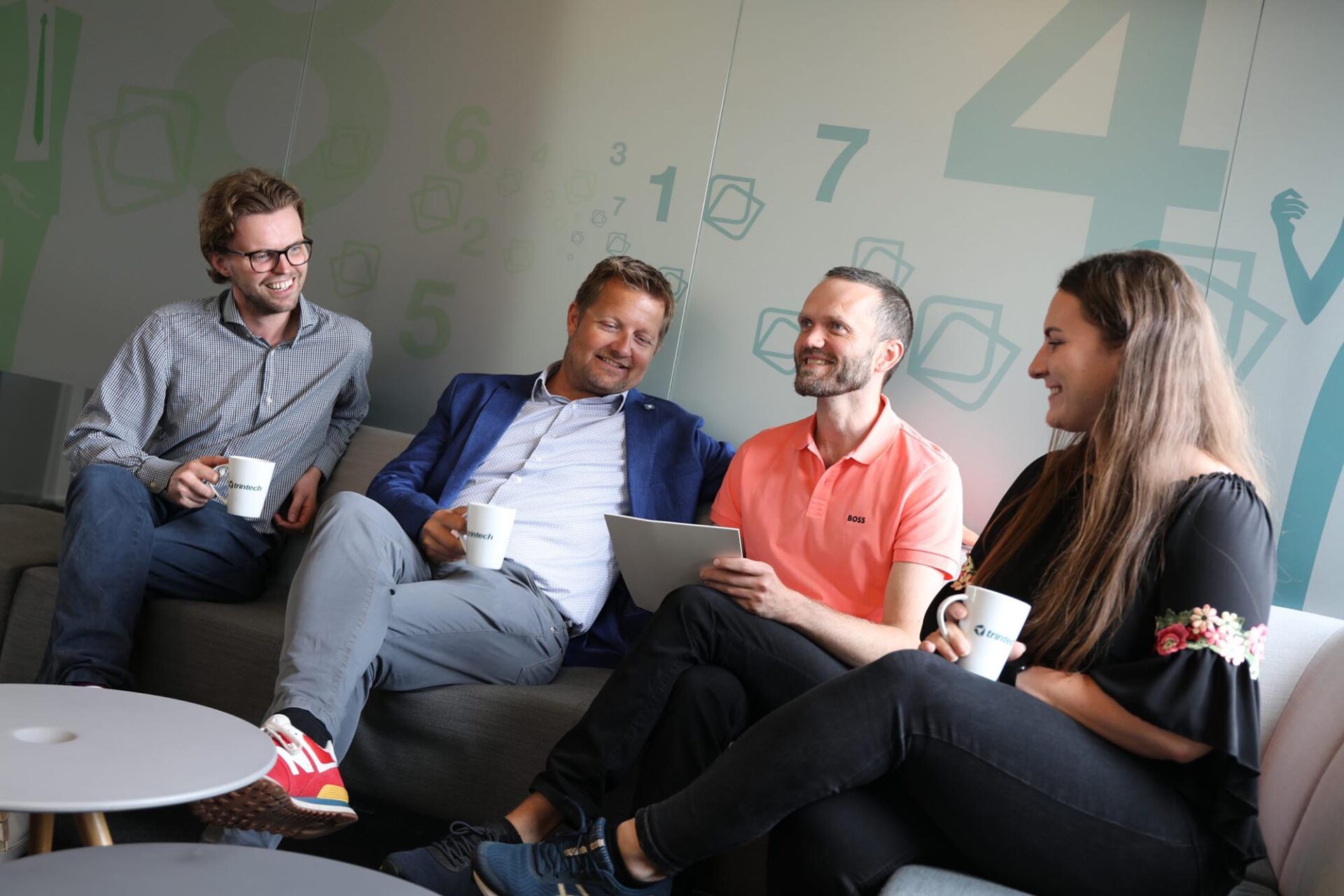 Trintech services team collaborating in a casual setting to support finance professionals with financial close services