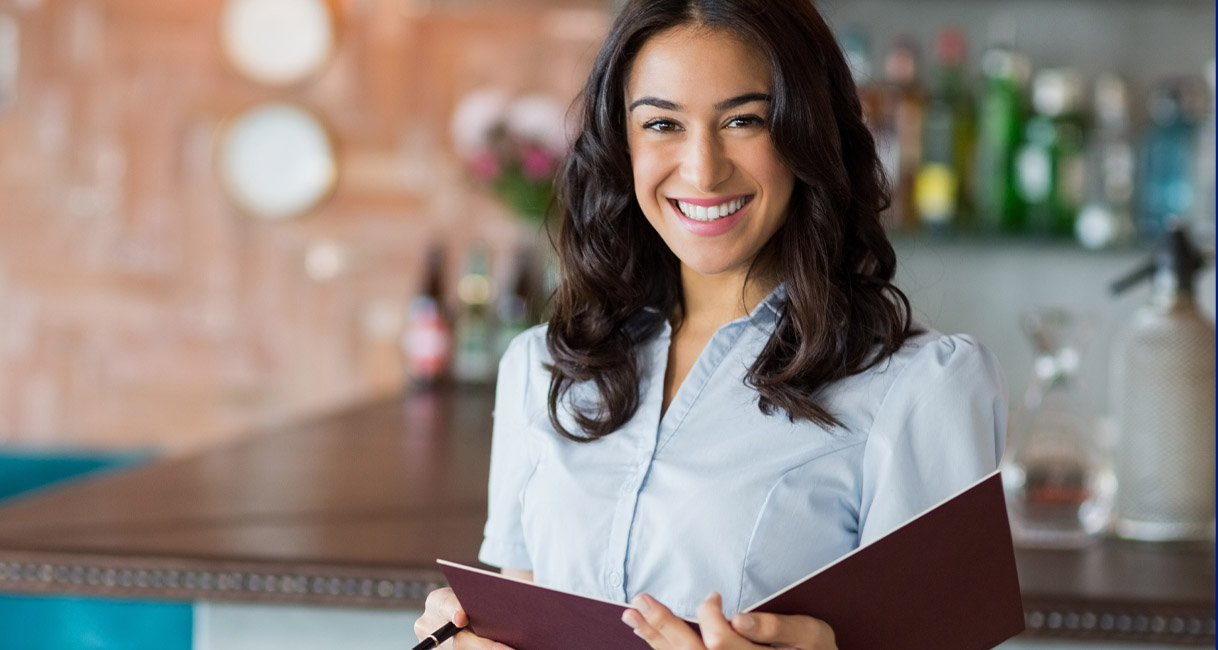 Woman holding a menu for an article about a faster financial close for the restaurant industry.